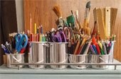 Art supplies in tin buckets.