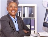 Smiling, African-American woman in an office setting.