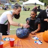 People painting pumpkins