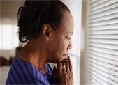 African-American woman - pensive - looking out window