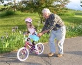 grandfather - granddaughter - riding bicycle