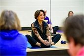 older woman exercising on floor mat
