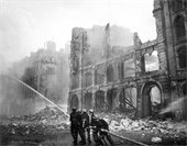 Firemen at work in bomb-damaged street in London, after Saturday night raid, ca. 1941. New Times Paris Bureau Collection. (USIA)  Exact Date Shot Unknown  NARA FILE #: 306-NT-901C-11  WAR & CONFLICT BOOK #: 1007