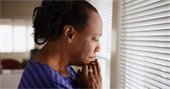 black woman - pensive - by window
