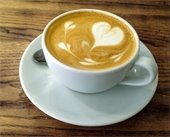  cup - heart shaped cream in coffee - wood table