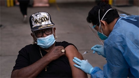 Black patient receiving COVID vaccine