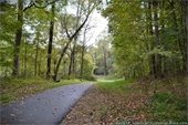 Riverwalk Greenway - Hillsborough NC. Photo of paved path through the woods.