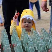 Child throwing ring at bottle toss at Halloween Spooktacular