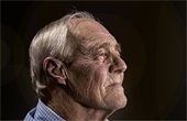 older white man gazing into distance.