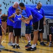 Basketball coach talking to youth player