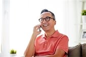 Older Asian man - smiling - talking on phone