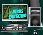 desktop computer - screen reads "Virus Detected!"