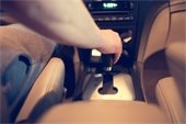 Driver's hand on gearshift in car