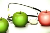 Graphic of 2 green and 1 red apple with a stethoscope.