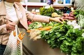 Woman grocery shopping for produce