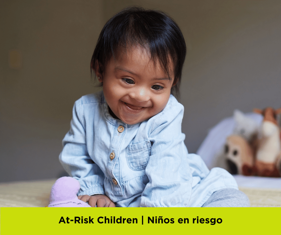 The CMARC program offers services for high-risk children. More information below. Image of a young child with Down's Syndrome, smiling while sitting on a bed. 
