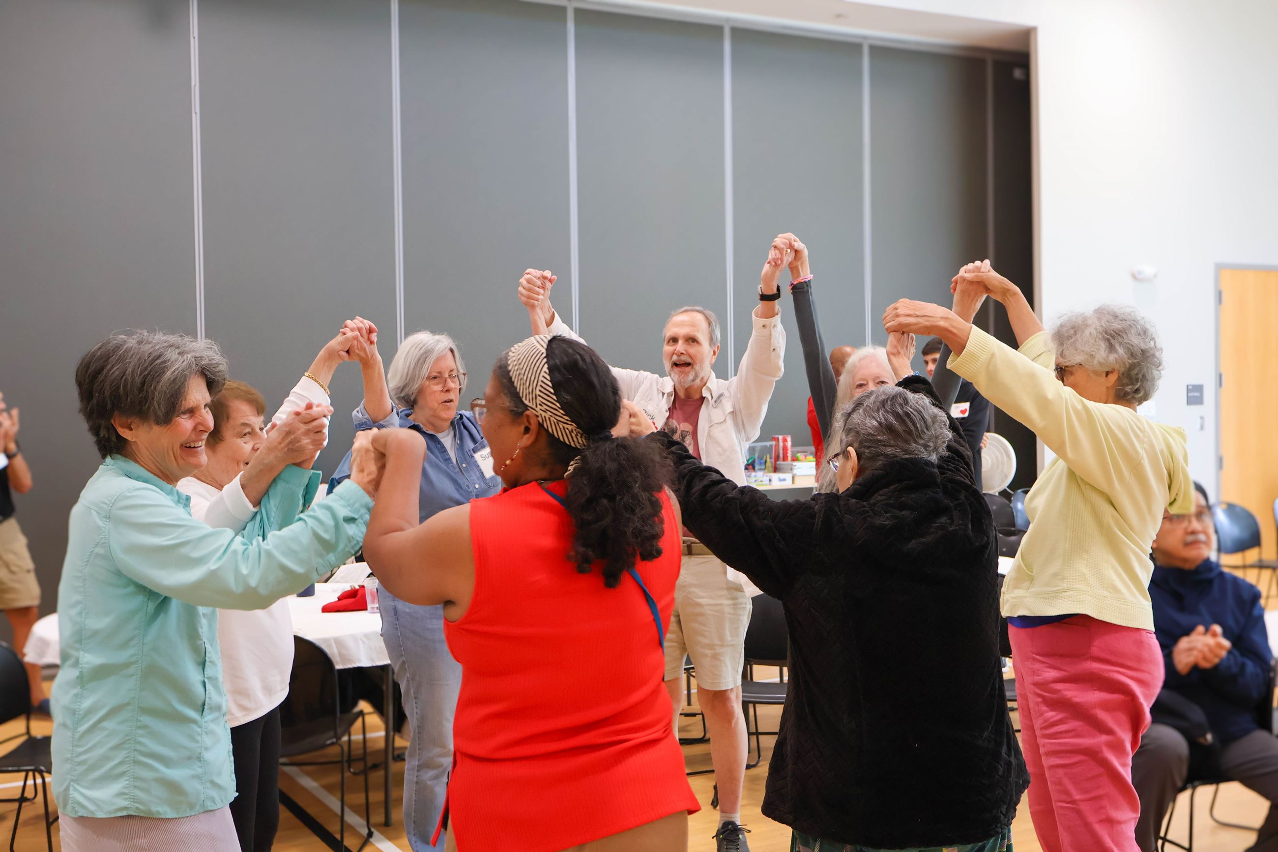 group holding hands and dancing in a circle 