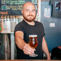 Tim Schwarzauer at Dingo Dog holding a beer