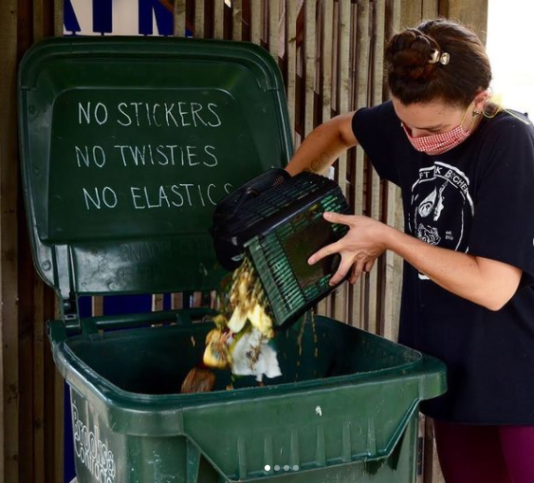 putting food scraps into a food waste cart