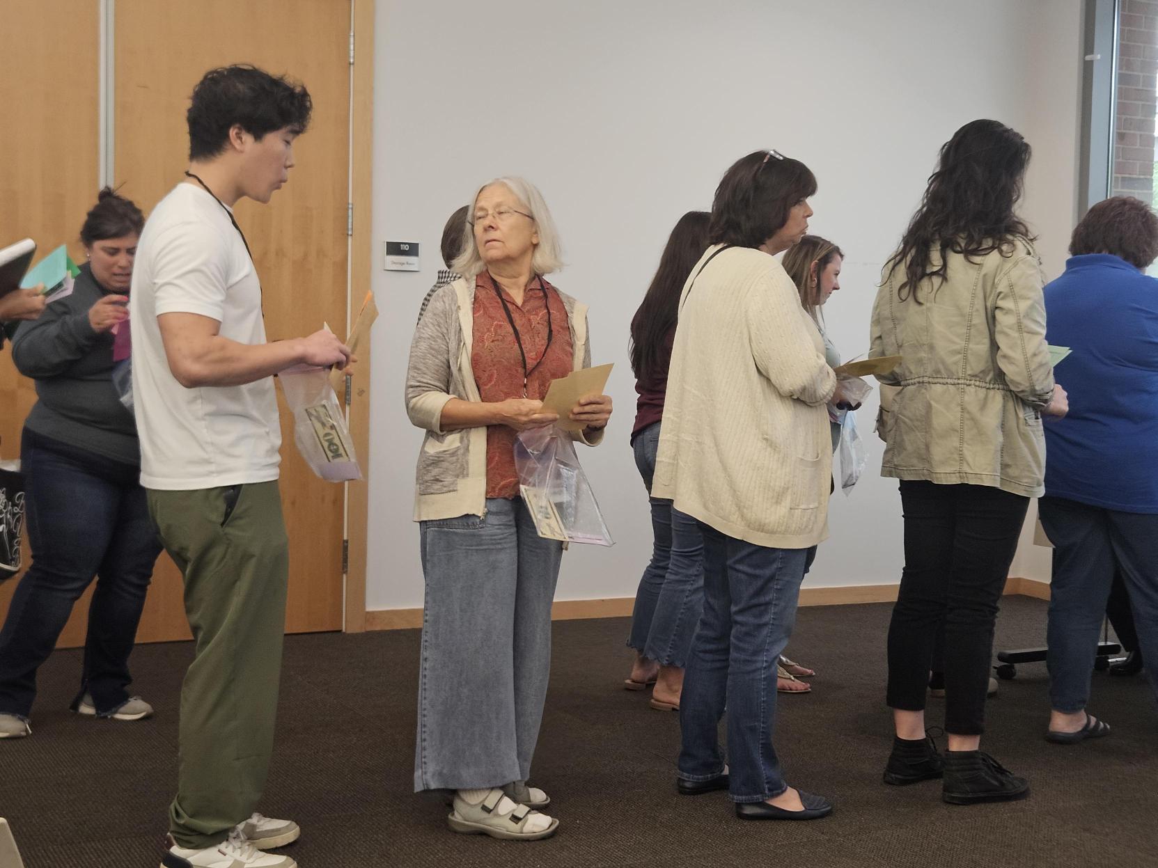 Orion, LRC intern, standing in line behind a few people, at Chapel Hill library reentry simulation